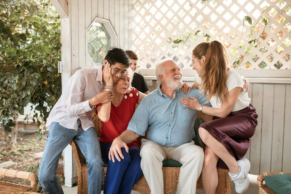 picture of grandparents laughing with apparently 2 of their grandchildren. the picture is an example of one of the key risk factors